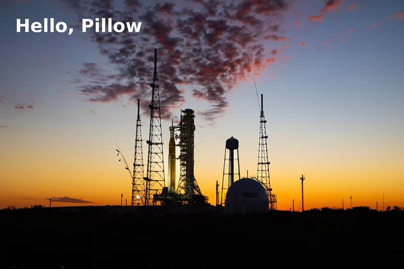 A launch pad sunset photo with the words Hello, Pillow in white in the top-left corner